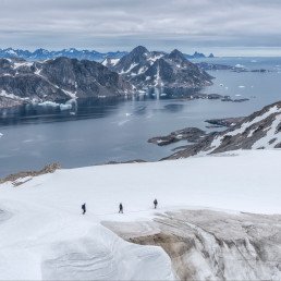 Greenland, Sermersooq, Kulusuk, Schweizerland Alps, three people walking in snow